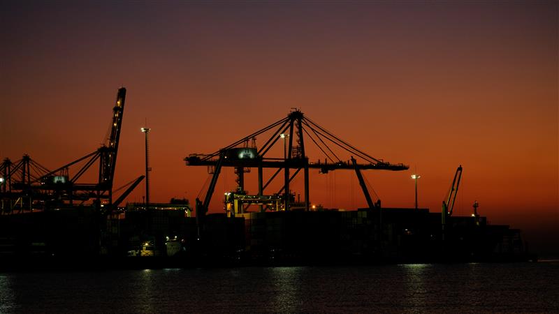 Quay cranes at a container terminal at dusk